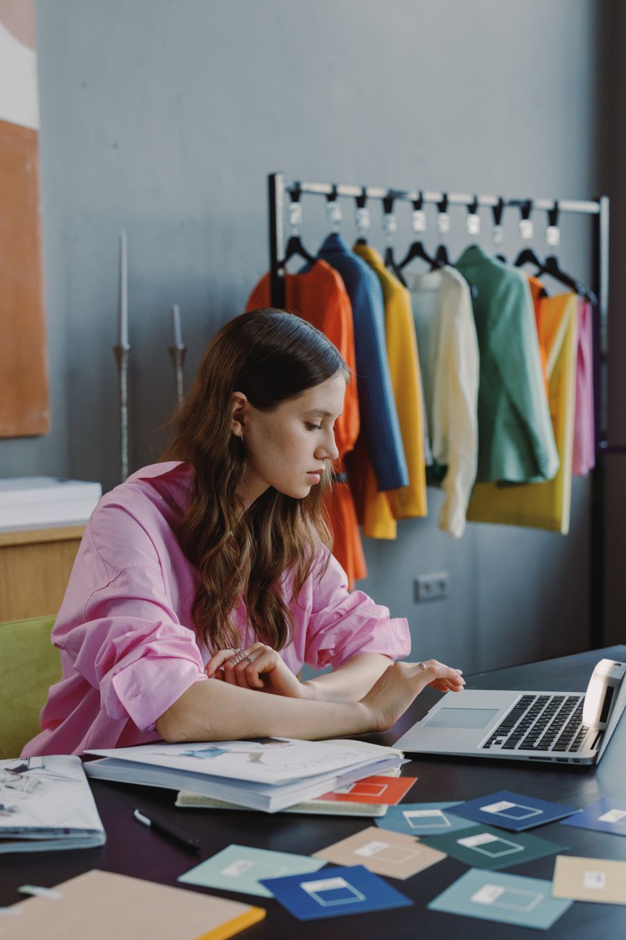 Designer working on a laptop at a studio table — photo by Ron Lach on Pexels