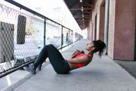 Side View of a Woman in Activewear Doing Sit-Ups