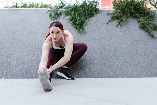Woman in activewear performing a stretch outdoors, showcasing fitness and motivation.