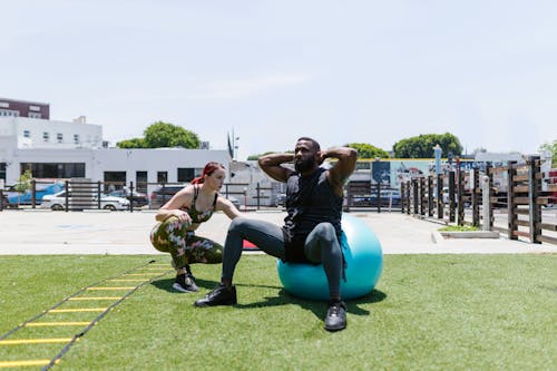 Man Doing Exercise Beside a Woman