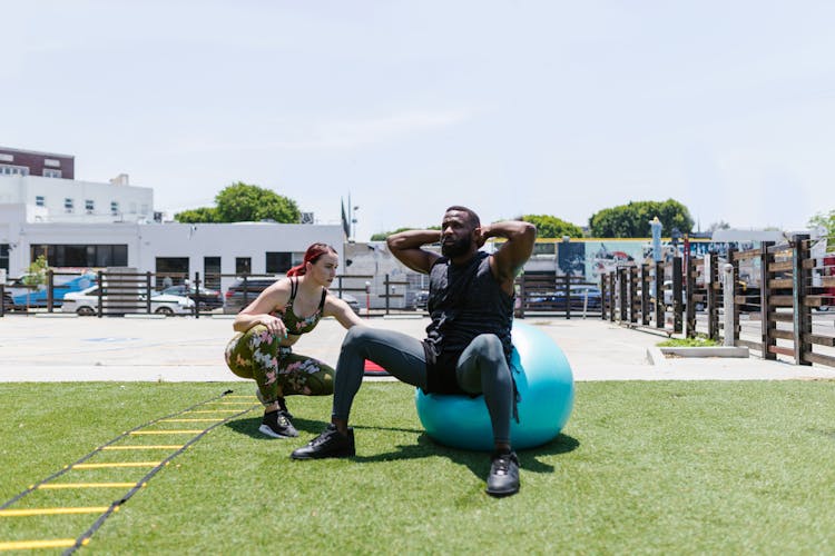 Man Doing Exercise Beside A Woman