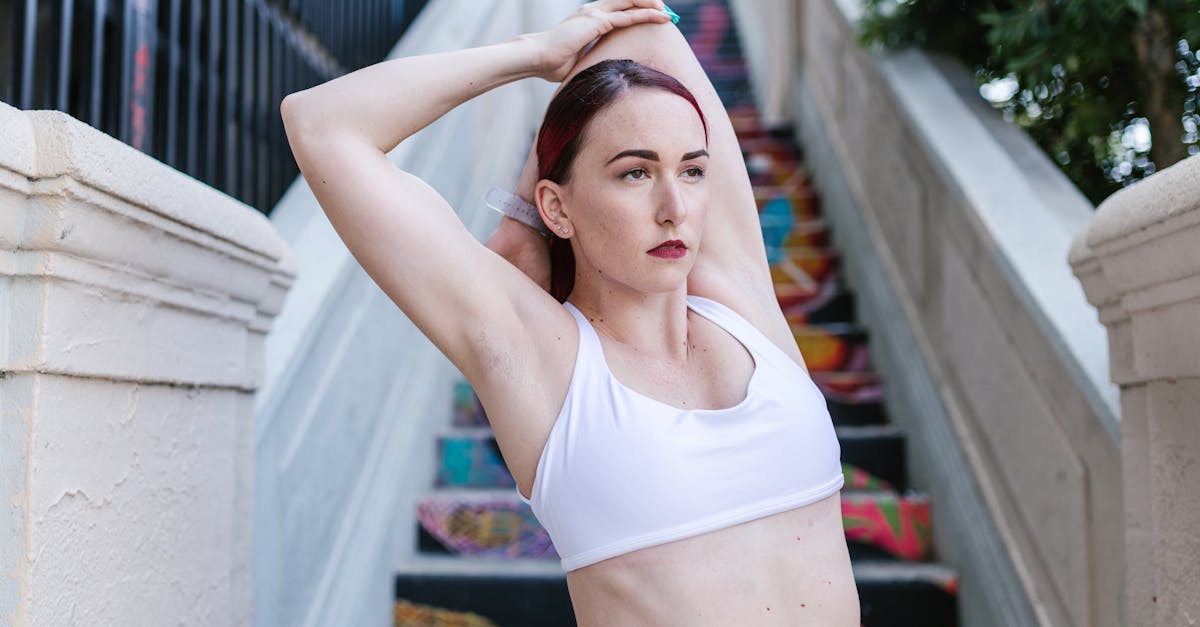 Woman Wearing a White Sports Bar Stretching Her Arms
