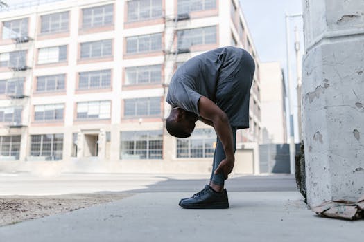 Man stretching outdoors in an urban setting, promoting a healthy lifestyle.