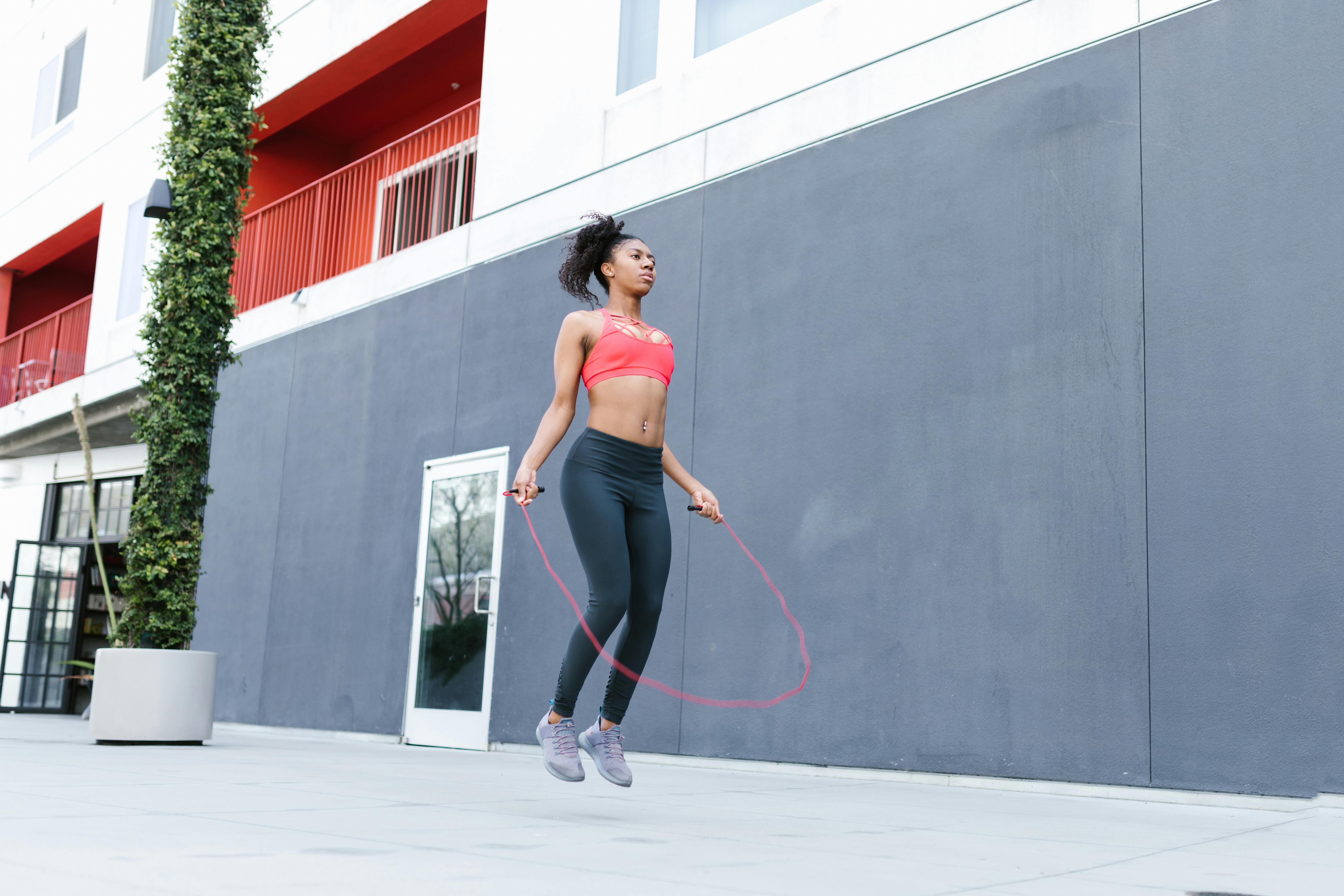 Woman Wearing a Sports Bra and Leggings Skipping Rope · Free Stock