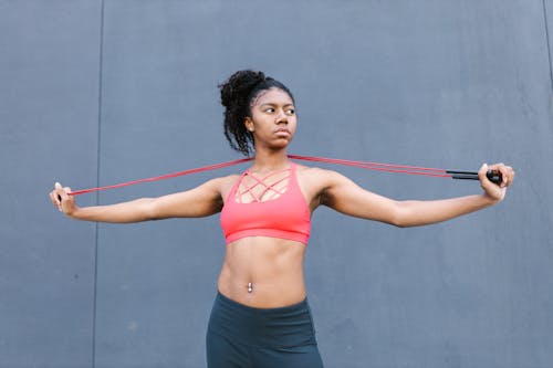 Woman in Active Wear Stretching a Rope