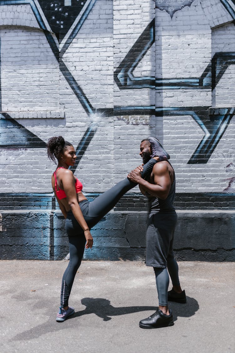 A Woman In Red Tank Top Doing A Workout