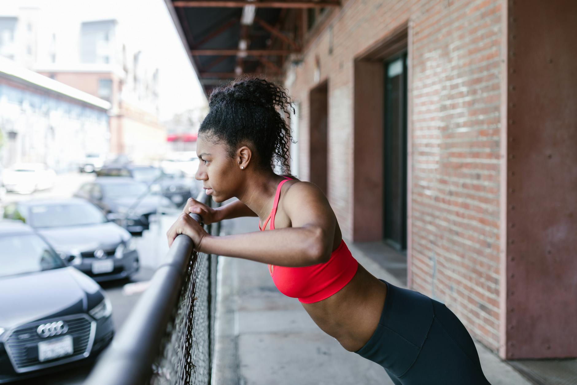 https://www.pexels.com/photo/woman-doing-exercises-on-a-metal-fence-8401803/