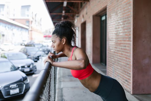 Young woman in activewear doing a workout outdoors against a cityscape.