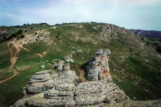 Dramatic landscape of Crimean mountains with distinct rock formations under a clear sky. Perfect for nature enthusiasts.