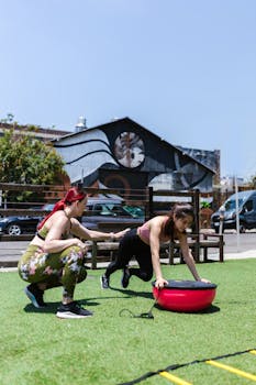 Women engaging in an outdoor fitness routine using balance equipment.