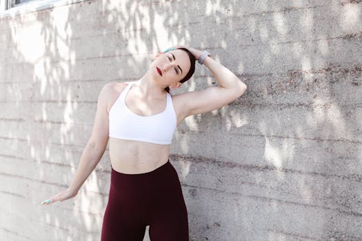 Fitness enthusiast stretching against a wall outdoors, showcasing a healthy lifestyle.