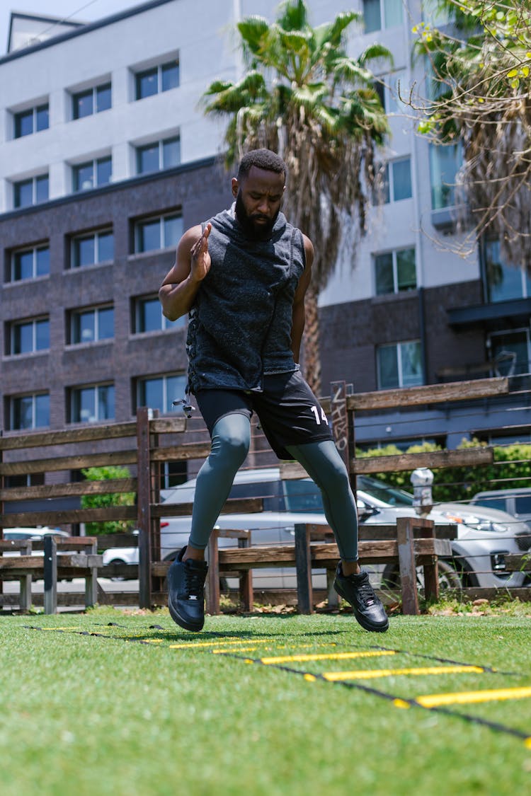 A Man In Black Tank Top Jogging