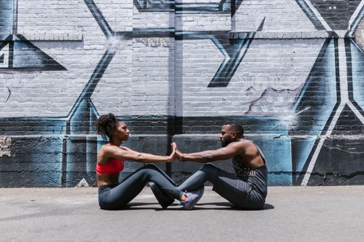 Couple Near Brick Wall Doing Street Workout