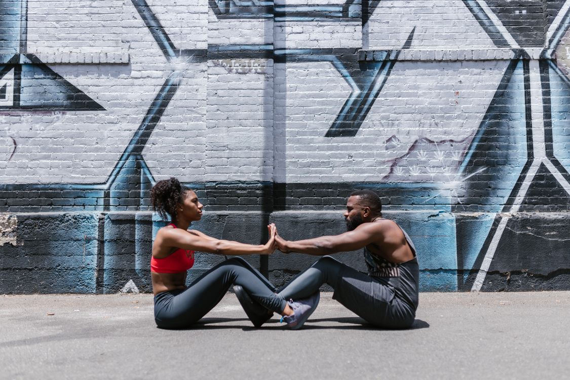 Free Couple Near Brick Wall Doing Street Workout Stock Photo