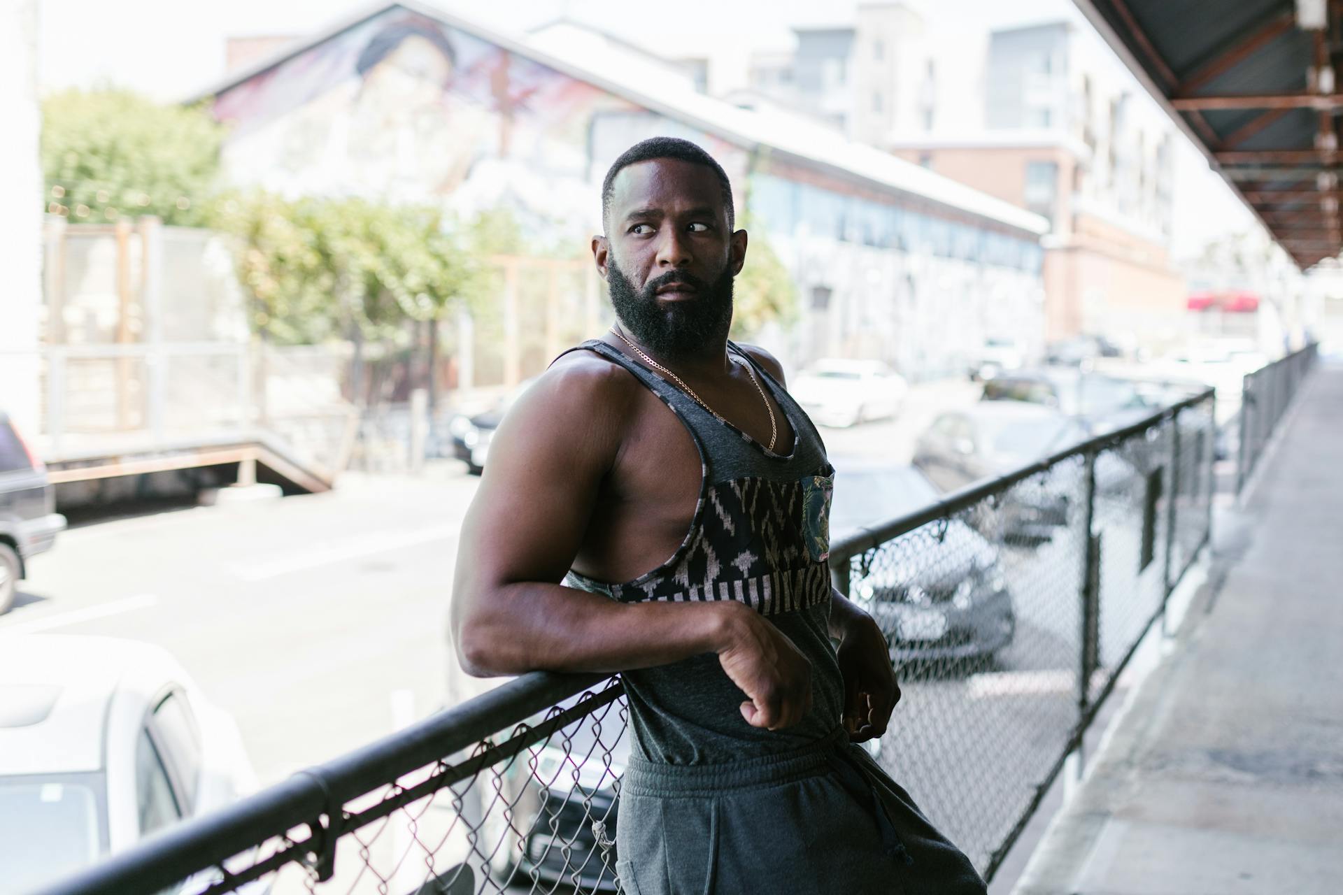 Muscular Man Leaning on Handrail