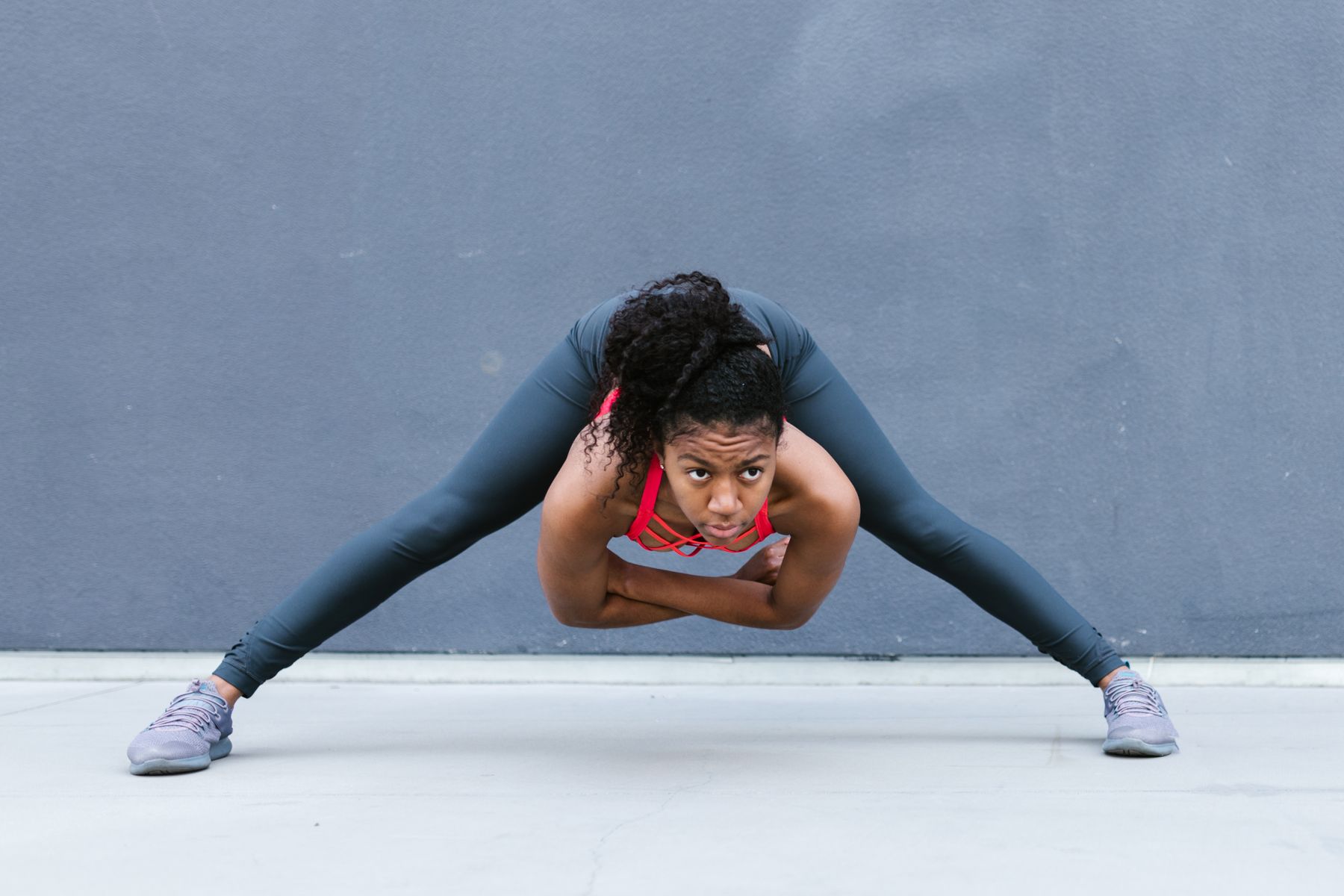 Athletic woman in leggings stretching outdoors