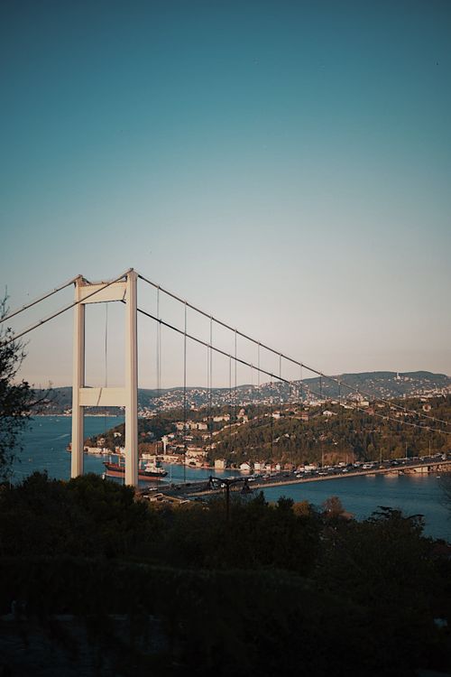 Free Stunning view of the Bosphorus Bridge in İstanbul at dusk with a vibrant urban backdrop. Stock Photo
