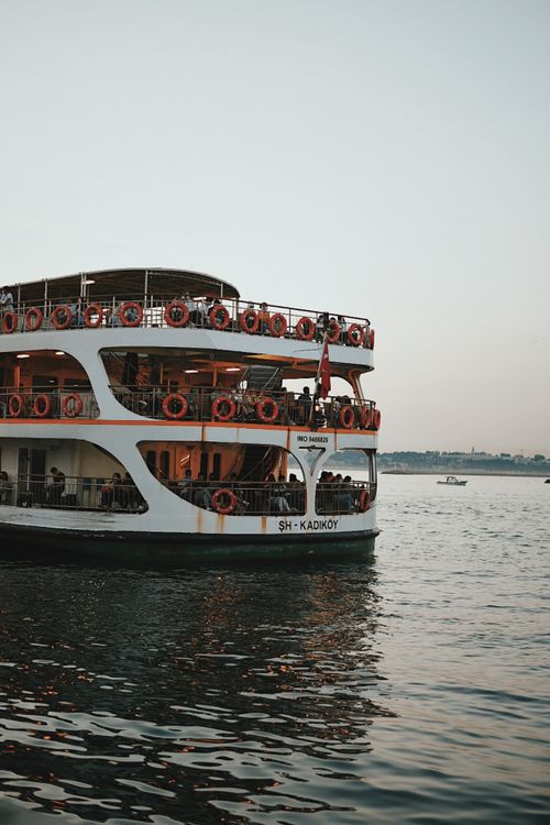 Free A ferry cruising the Bosphorus in İstanbul captures the picturesque summer evening vibe. Stock Photo