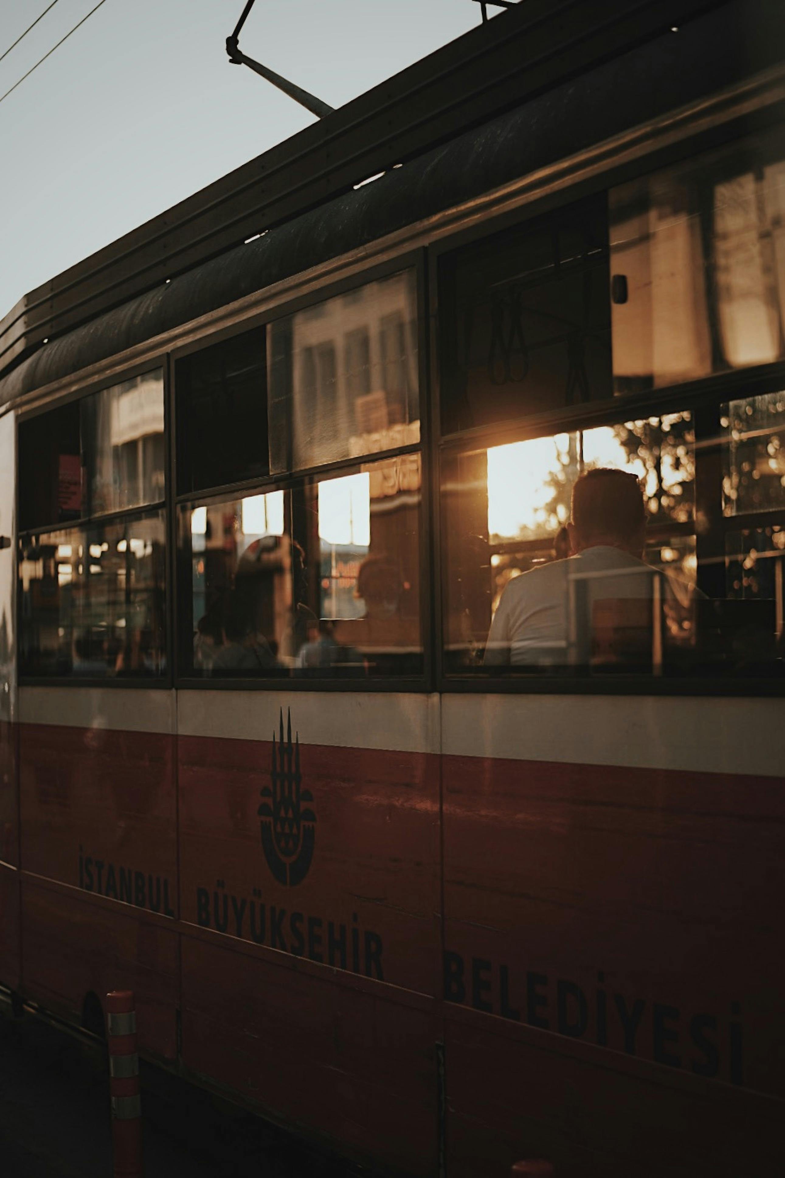 Free A serene sunset view captured from a moving tram in Istanbul, showcasing city life. Stock Photo
