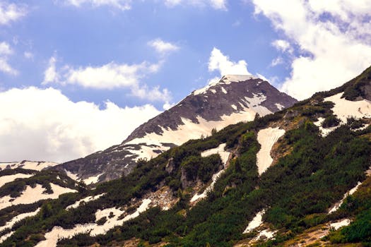 Stunning view of snow-covered mountains in Pirin National Park, Bulgaria under a clear blue sky.