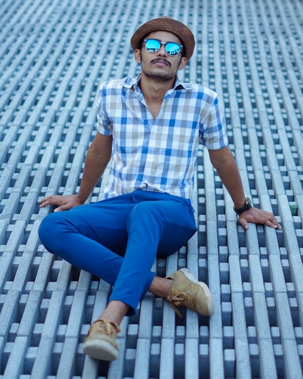 Man in Plaid Button Down Shirt Sitting on the Floor