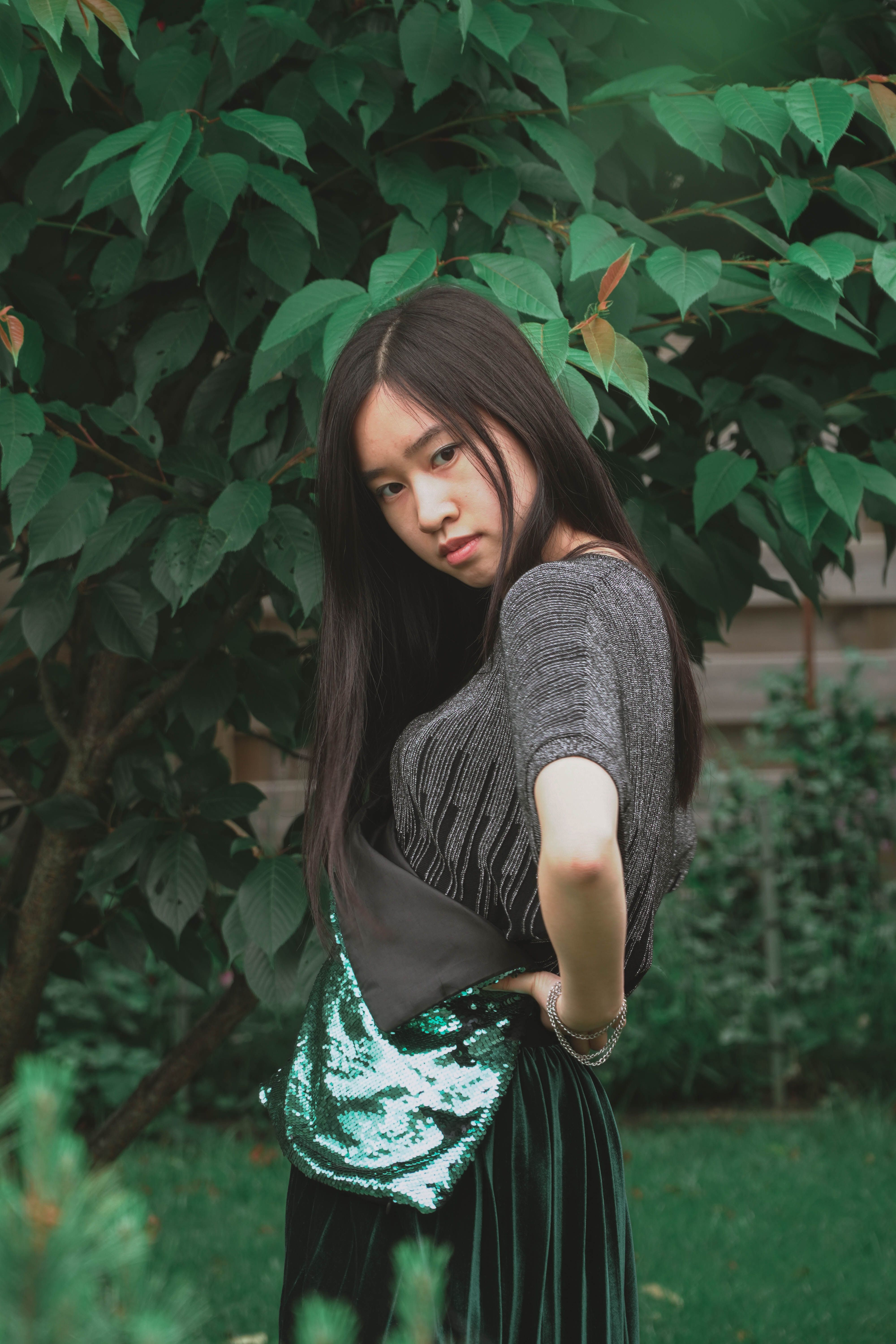 Woman Wearing a Gray Shirt Standing Beside a tree · Free Stock Photo