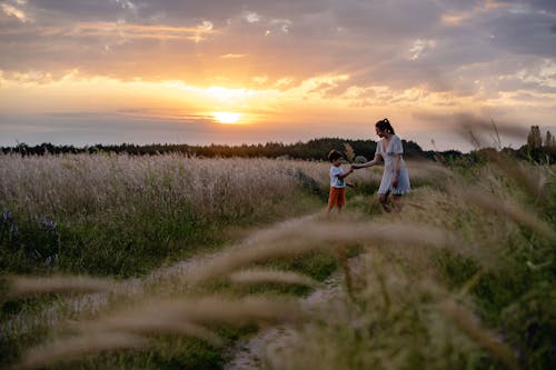 Mother and Son Standing on the Field