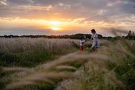 Mother and Son Standing on the Field