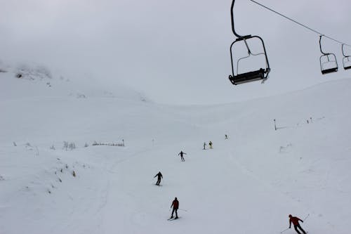 People Skiing on Snow Covered Mountain