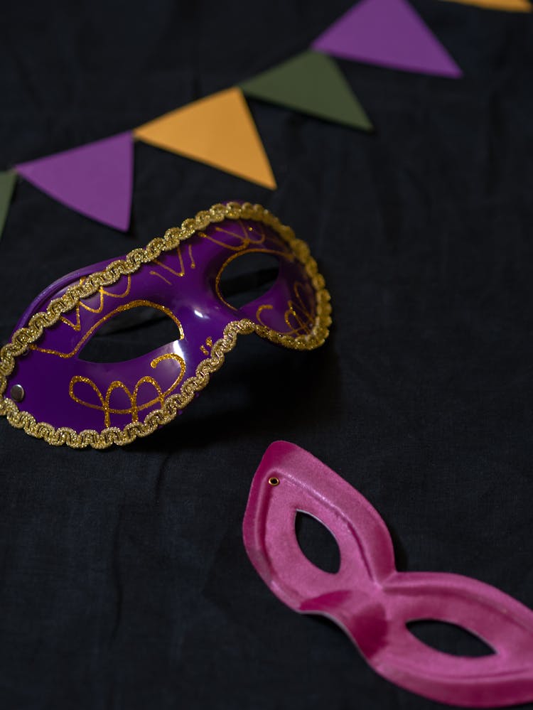 Purple Mardi Gras Masks On Black Surface