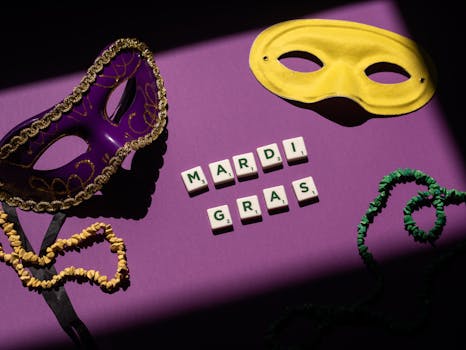 Mardi Gras themed still life with masks and letter tiles on a purple background.