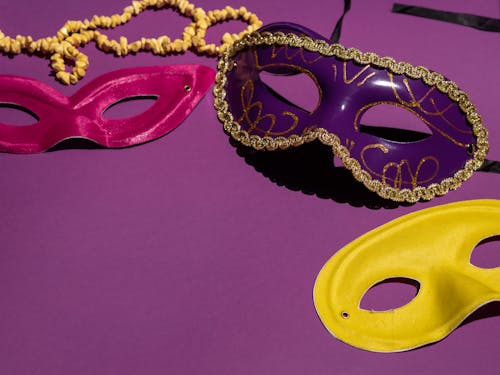 Free Different Colored Masks on a Purple Surface Stock Photo