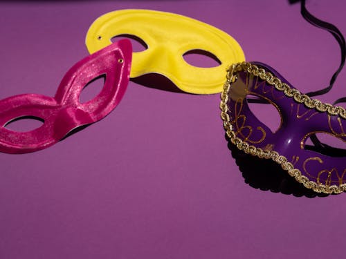 Free Close-up of Masquerade Masks on Purple Background Stock Photo