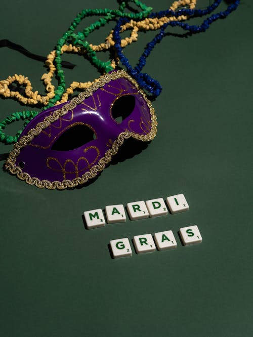 Purple and Gold Mask on Green Surface