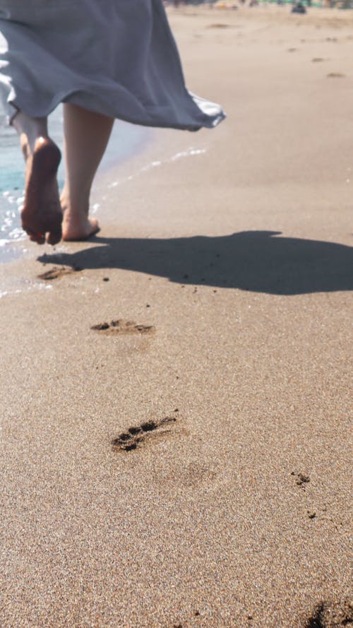 Barefooted Person Walking on the Sandy Shore