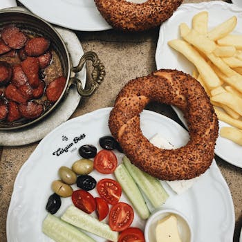 Enjoy a traditional Turkish breakfast featuring simit, sucuk, and fresh vegetables, perfect for a morning in Istanbul.
