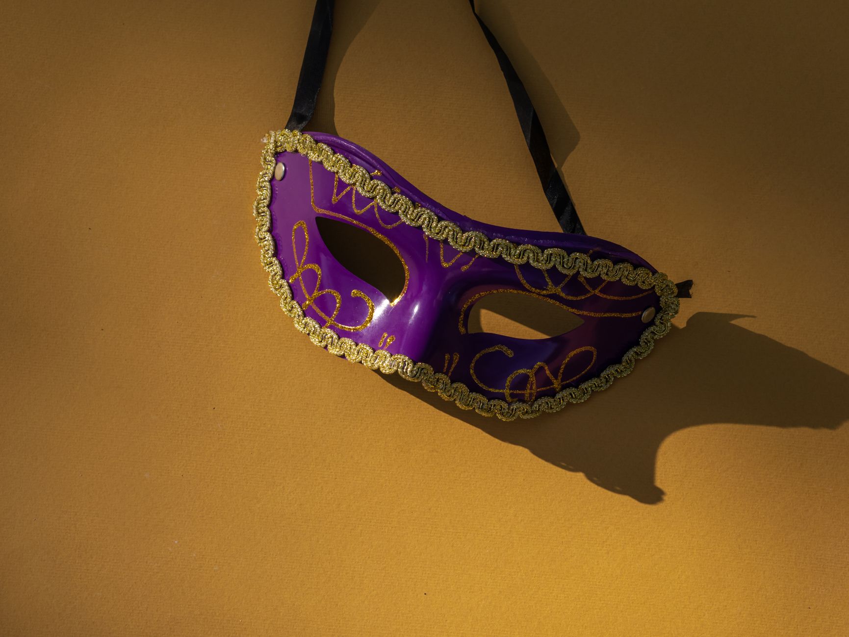https://www.pexels.com/photo/close-up-shot-of-a-purple-mask-on-a-yellow-surface-8405040/