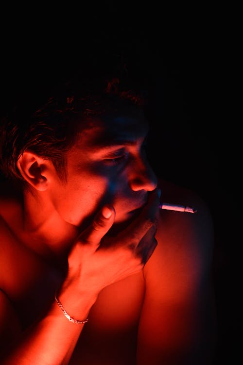 Topless Man Smoking Cigarette