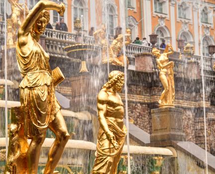 Gold Statues in a Fountain and Building Facade