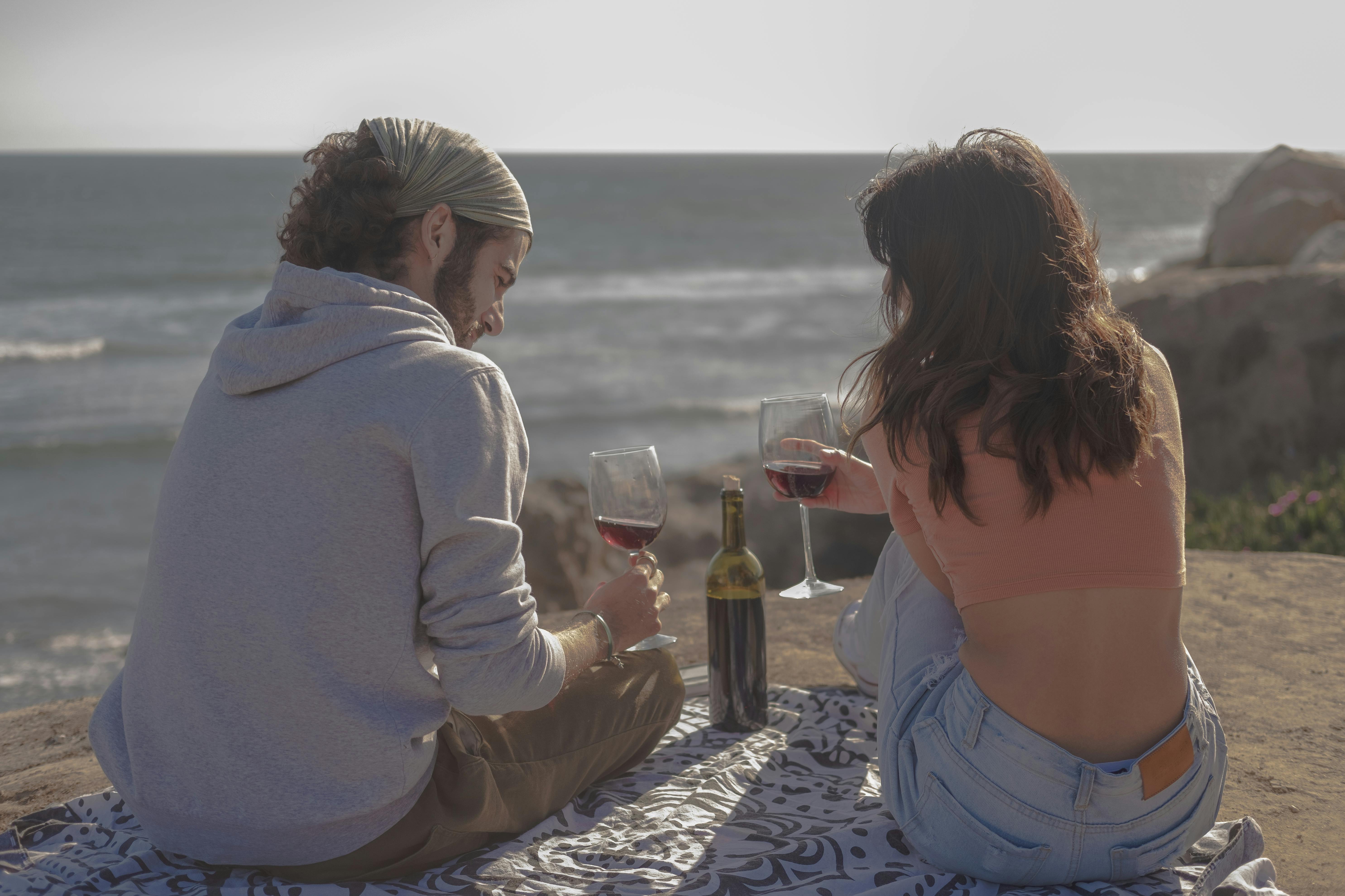 back view of a couple drinking wine together