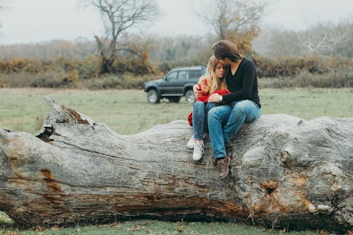 Free Mother and Daughter Sitting on Tree Log Stock Photo