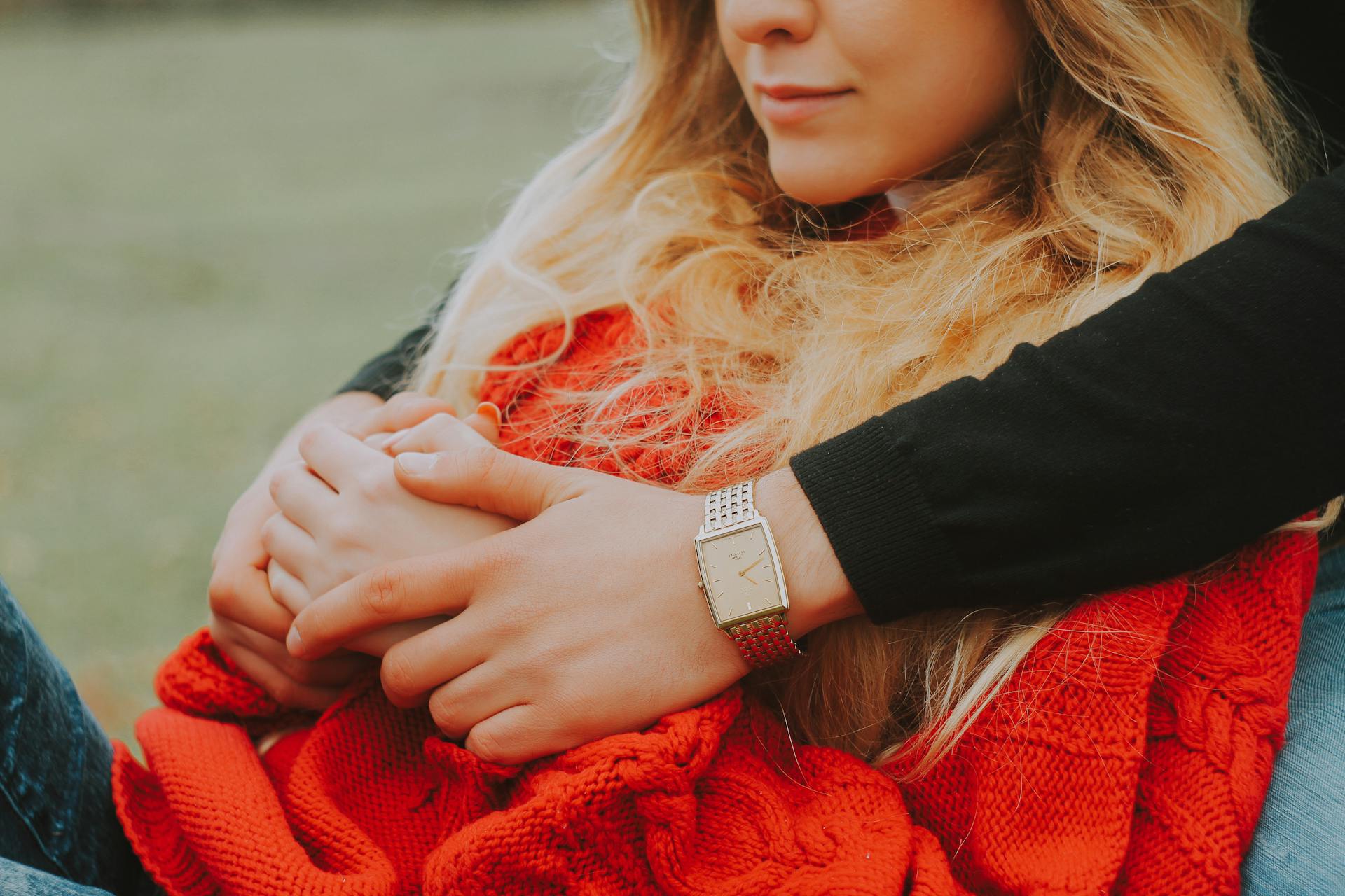 Couple enjoying a warm outdoor embrace, highlighting intimacy and connection.