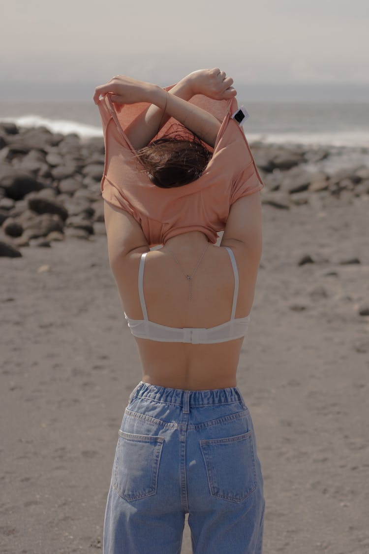 A Woman Undressing On The Beach