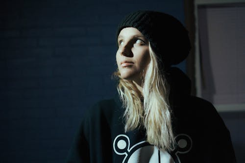 Photo of a Woman with a Black Beanie Looking Up