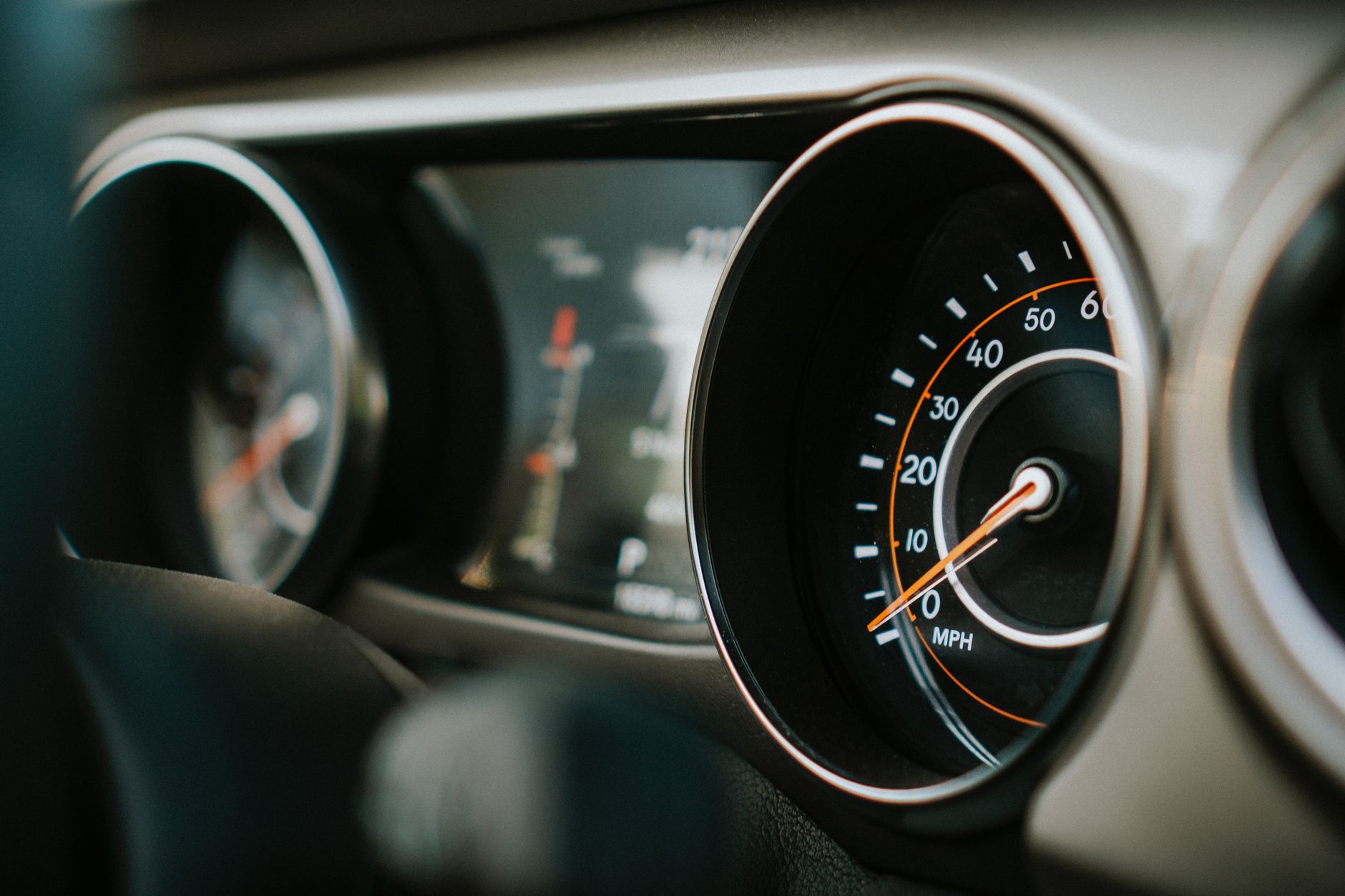 Close-up view of a car's speedometer and dashboard showing MPH.