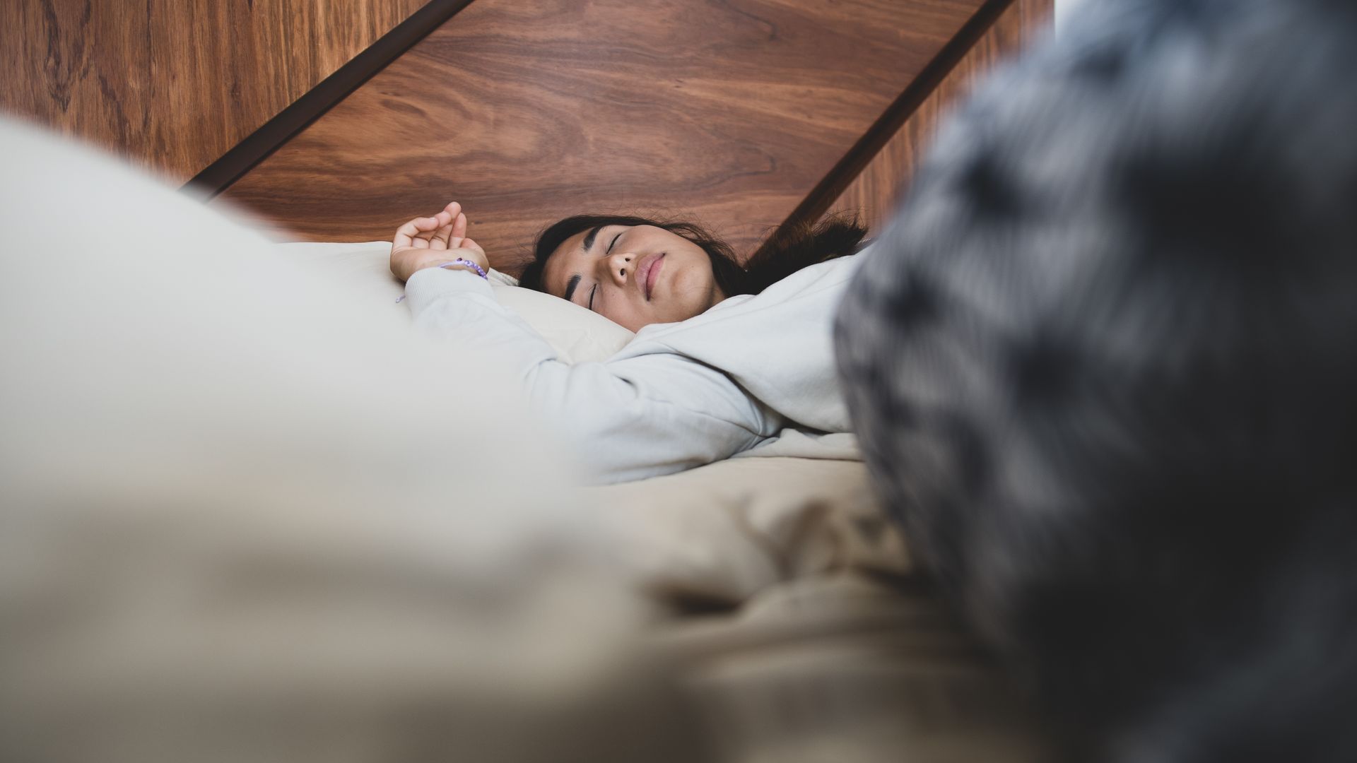 modafinil for sleep apnea: Guide A woman peacefully sleeping on a bed, conveying relaxation and comfort — modafinil for sleep apnea