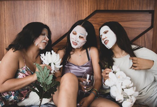 Three young women bond with face masks and flowers during a relaxing spa day indoors.
