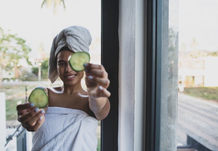 Woman Holding Cucumber For Face Mask