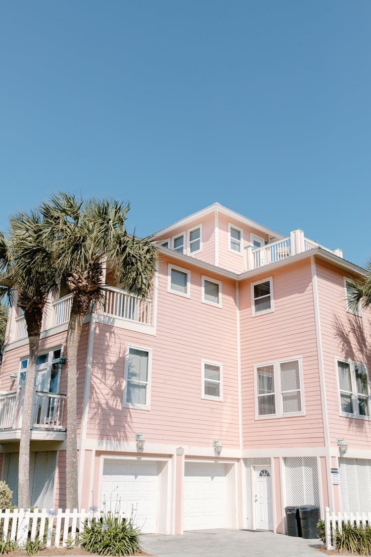 A Pink House Under A Blue Sky