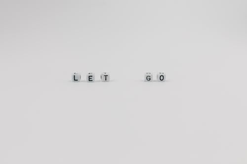 Free A Let Go Slogan Spelled with Letter Dice on White Background Stock Photo